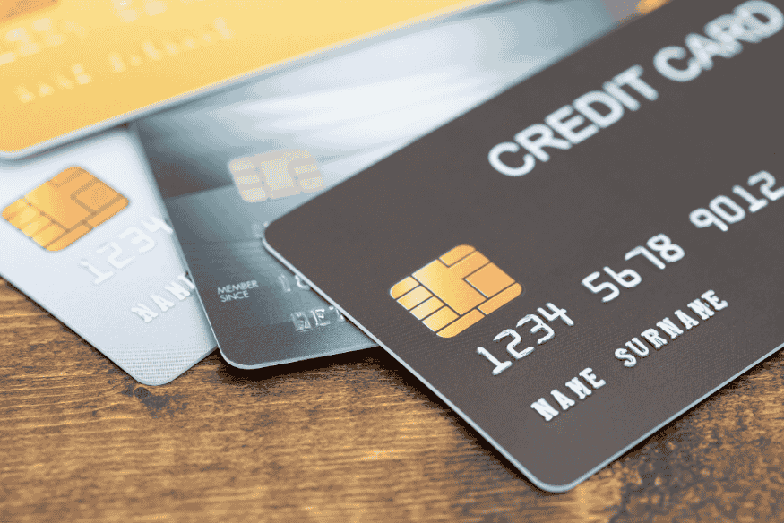 Close-up of several credit cards on a wooden table