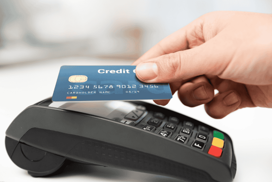 Credit card being inserted into a payment terminal for travel-related purchases